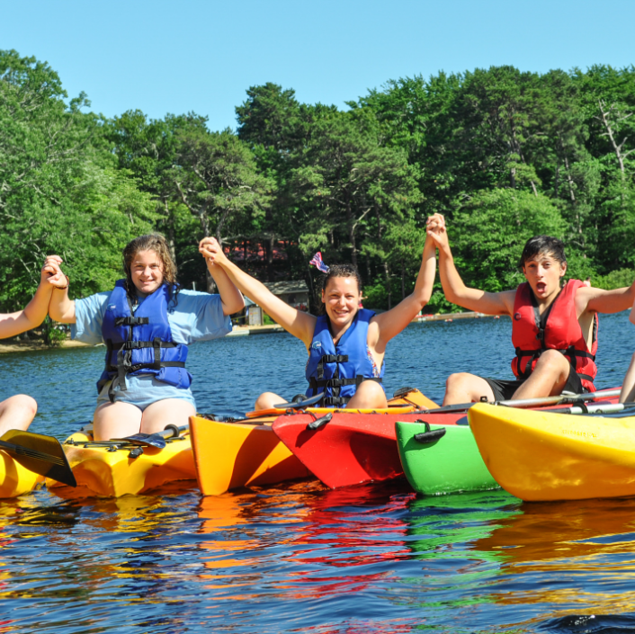 Kids kayaking holding hands