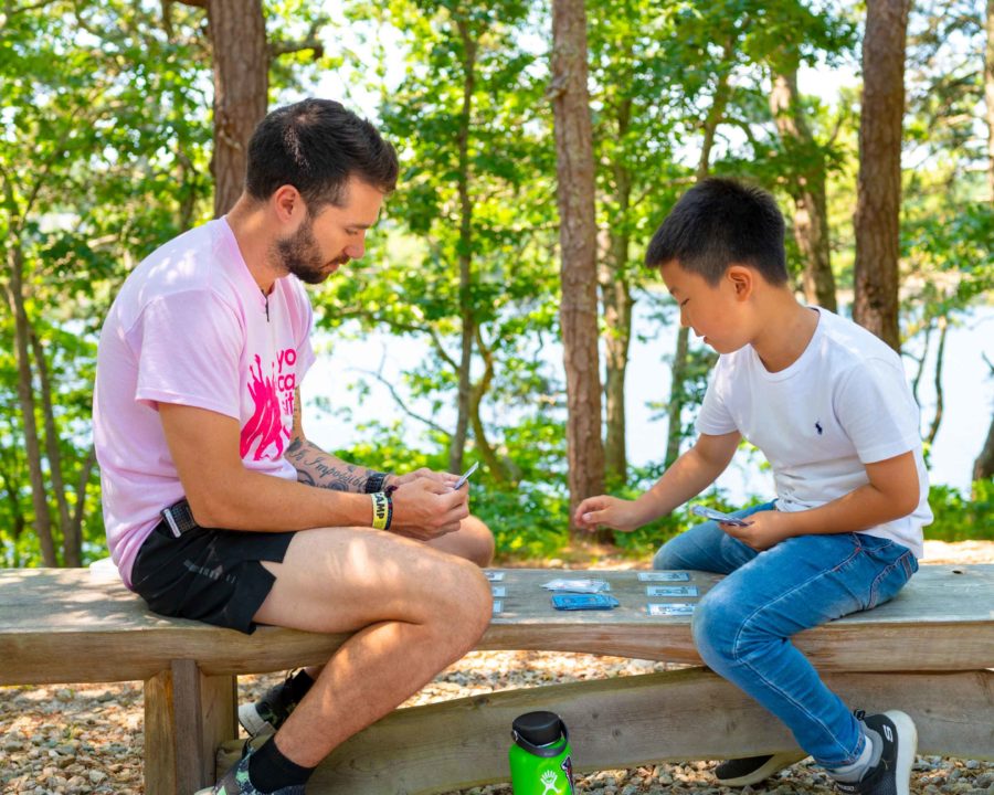 Counselor and camper playing cards