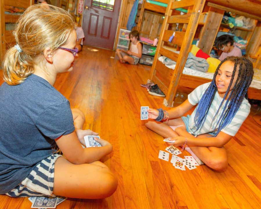 Campers playing cards in their bunks