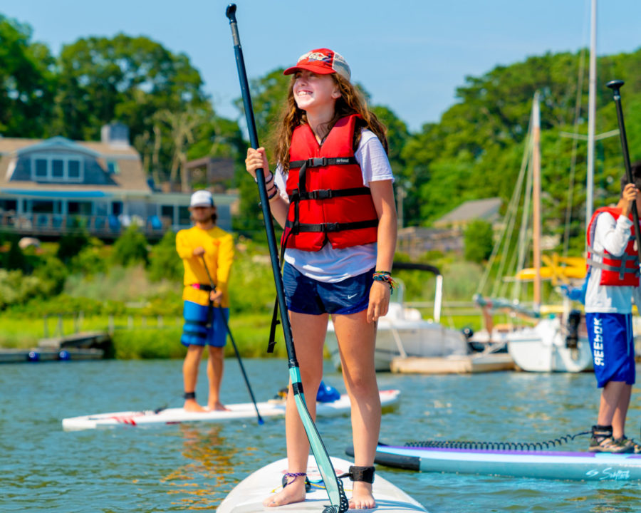 Camper stand up paddle boarding